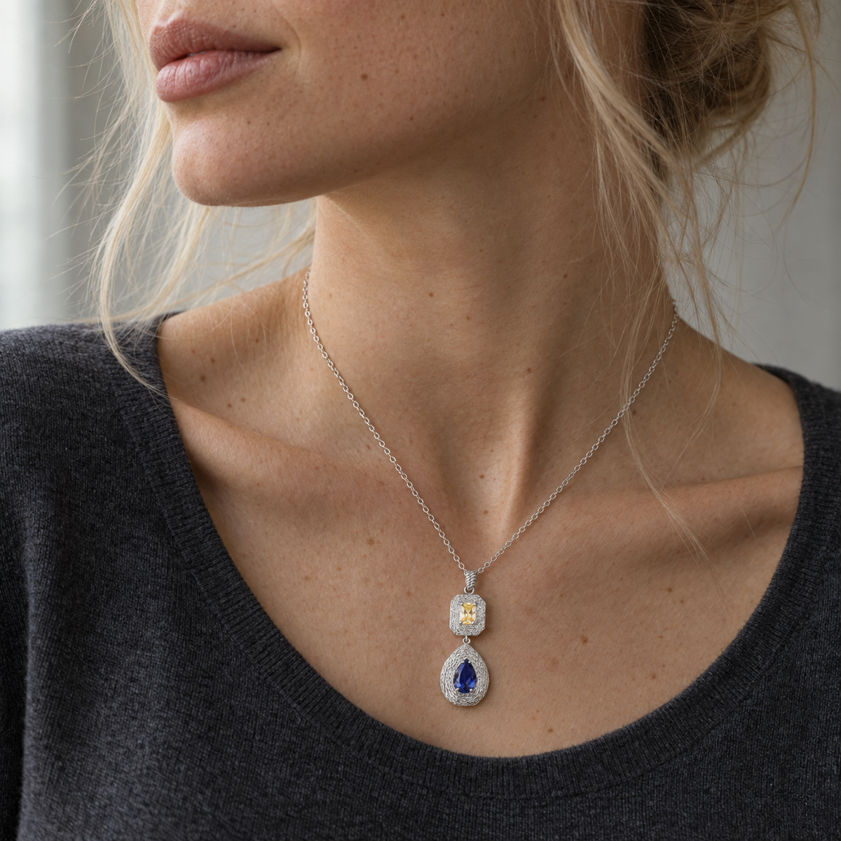 Ava sterling silver necklace with yellow and blue gemstones, close-up on model